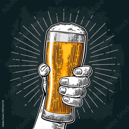 Male hand holding beer glass. Born to drink beer