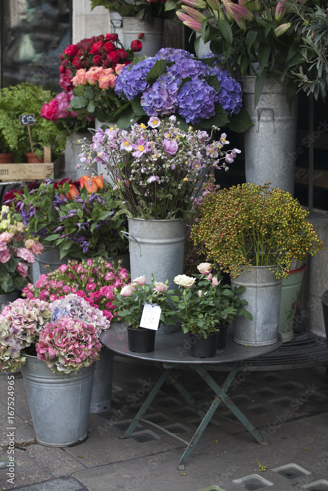 the Various flowers at the entrance to the store for sale for various occasions: weddings, birthdays, mother's day, Valentine's Day