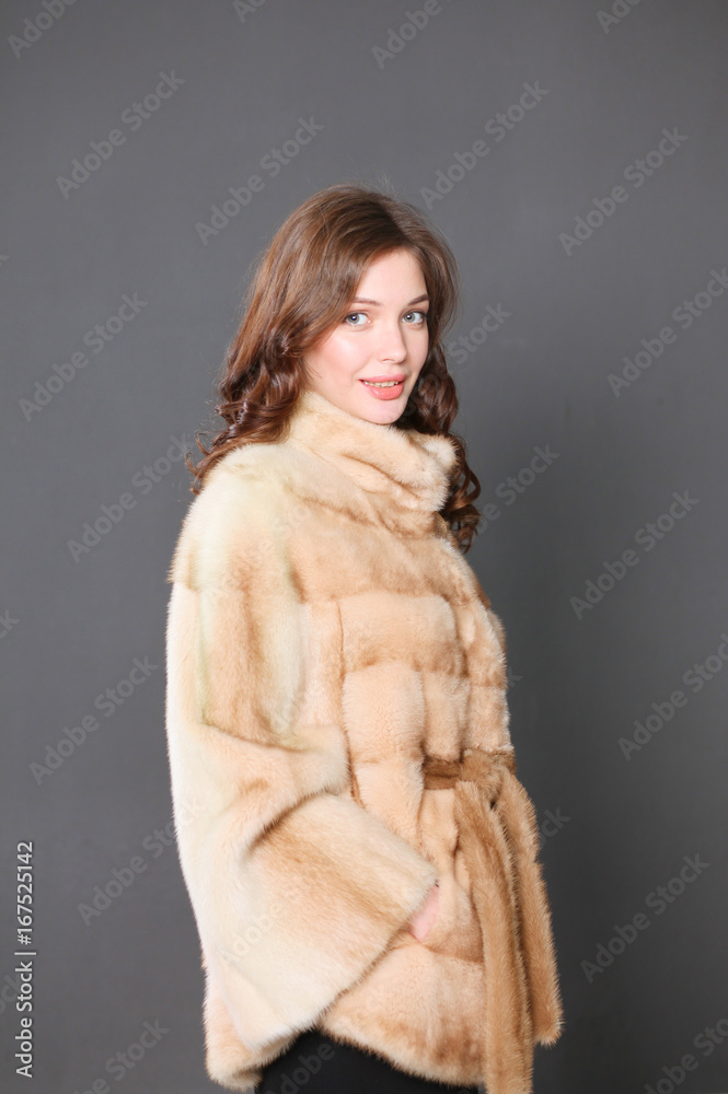 Portrait of a beautiful woman in jacket with fur. Portrait of a beautiful woman in jacket with fur.