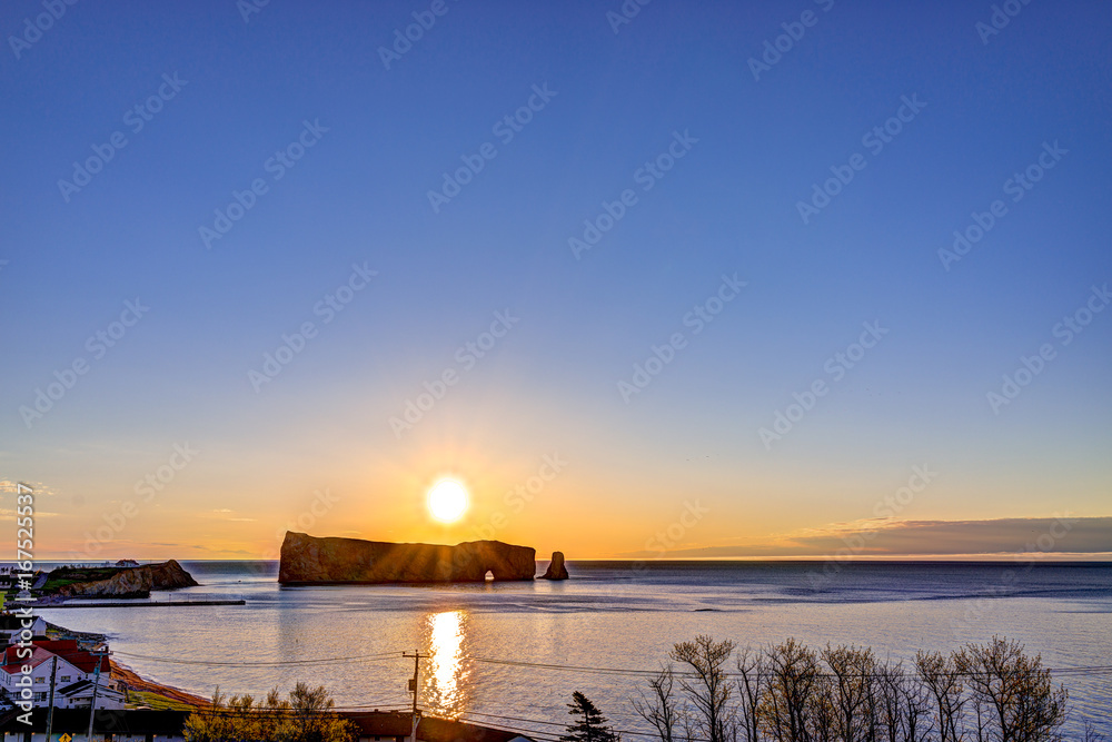 Famous Rocher Perce rock in Gaspe Peninsula, Quebec, Canada, Gaspesie region at purple sunrise and sun path