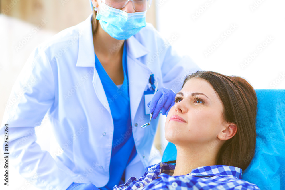 Woman dentist working at her patients teeth Woman dentist working at her patients teeth