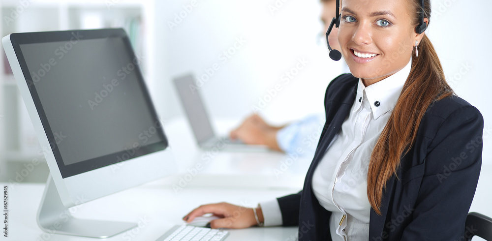 Happy female wearing headset and sitting on the desk Happy female wearing headset and sitting on the desk