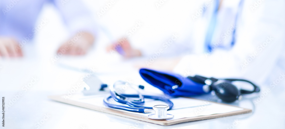 Fototapeta premium Doctor woman sitting with male patient at the desk