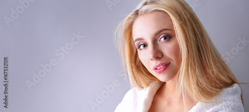 Smiling woman in white bathrobe photo