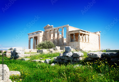 Erechtheion temple with green grass in Acropolis of Athens, Greece, retro toned
