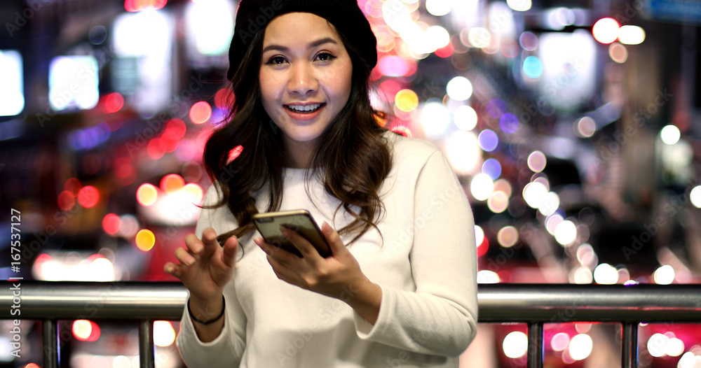 Young asian woman using her mobile phone
