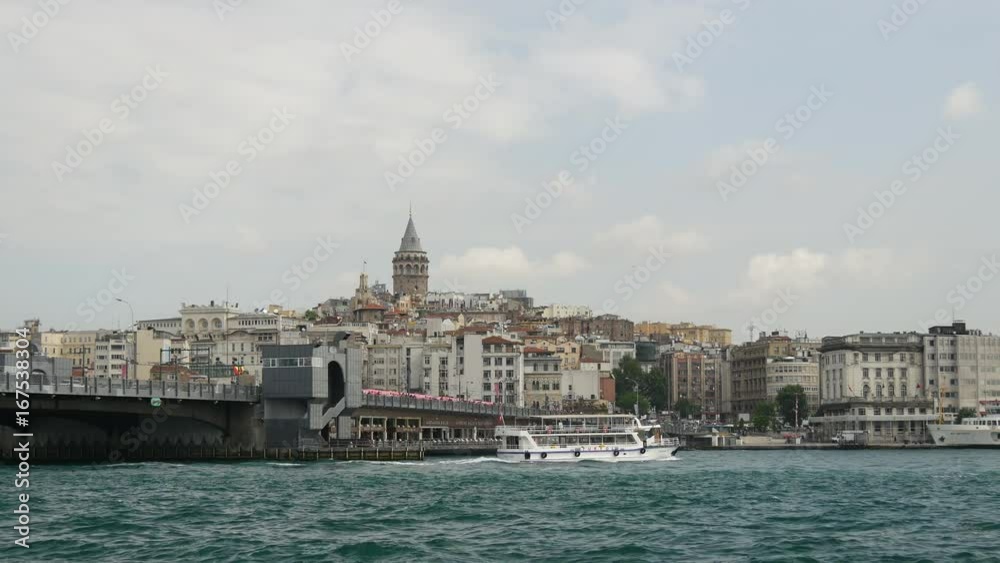 Galata Bridge and ferry with the Galata Tower on the background in Istanbul Turkey Galata Bridge and ferry with the Galata Tower on the background in Istanbul Turkey