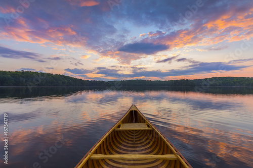 Murais de parede Bow of a cedar canoe on a lake at sunset - Ontario, Canada