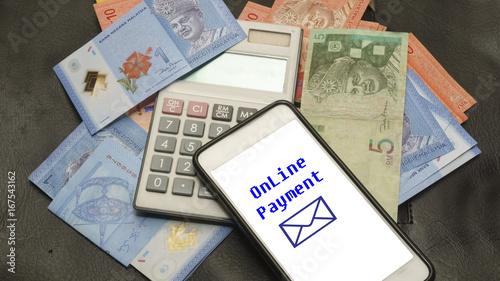 Paper money, caculetor, utility bills and smartphones with ONLINE PAYMENT, the online business concept.