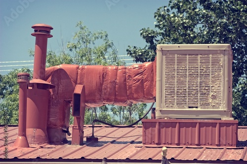 Old swamp cooler or evaporative cooler to show how bad the old units are with calcium build-up compared to new A/C. This is located in New Mexico, US.
 photo