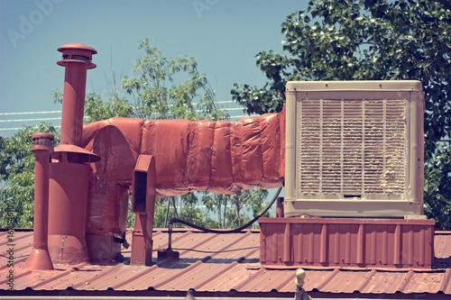 Old swamp cooler or evaporative cooler to show how bad the old units are with calcium build-up compared to new A/C. This is located in New Mexico, US.

