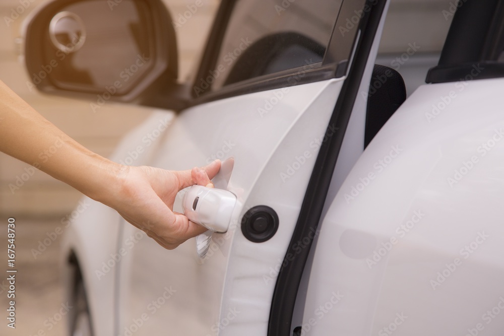 Hand is opening car door. Car wash concept