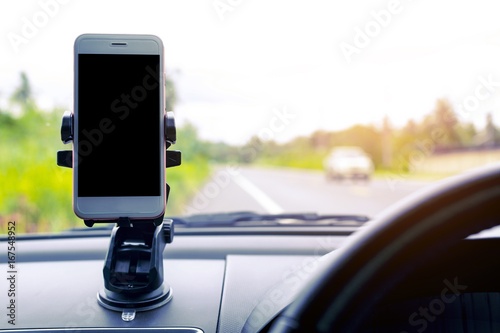 Smart phone in car It's arranged to put your pictures and information.road trip, travel, destination technology and people concept. © Patcharin