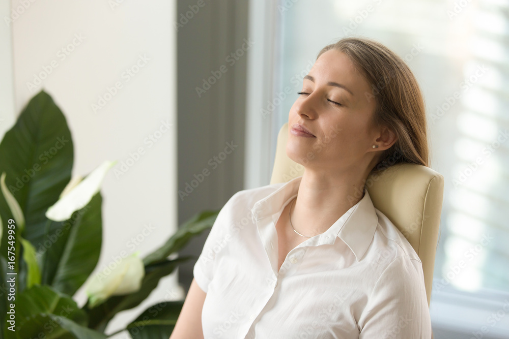 Calm attractive woman feeling relaxed in office home, peaceful mindful businesswoman leaning back on chair with eyes closed, meditating at work, taking deep breath to relax, no stress at workplace Calm attractive woman feeling relaxed in office home, peaceful mindful businesswoman leaning back on chair with eyes closed, meditating at work, taking deep breath to relax, no stress at workplace