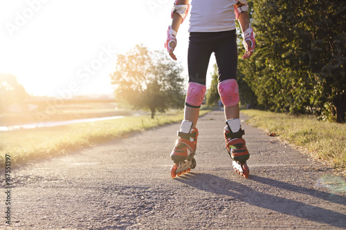 Close up of girl rollerblading in park. Outdoor, recreation, lifestyle, rollerblading.