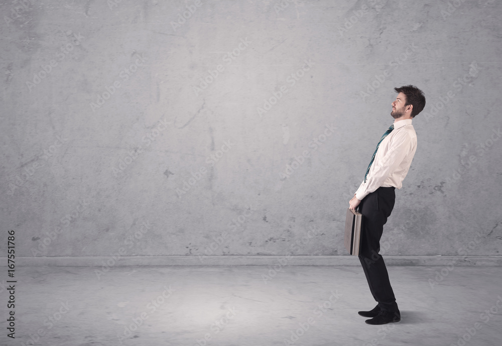 Young businessman standing confused