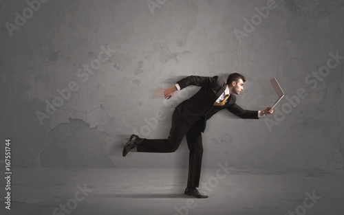 Running businessman with device in hand