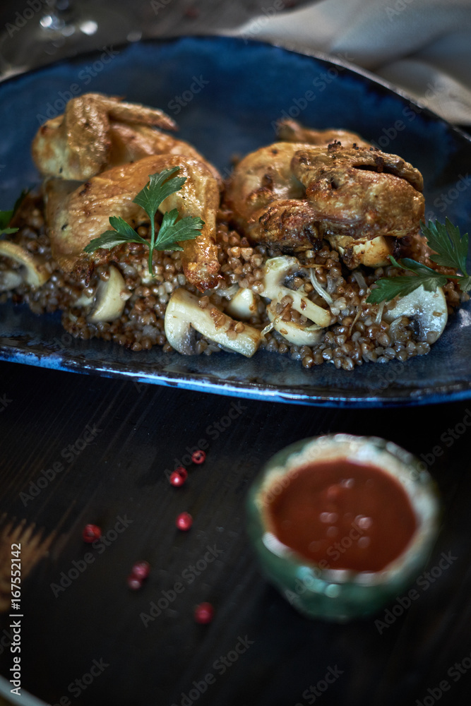 Fototapeta premium Grilled chicken Tabaka with sauce on stone plate. jpg
