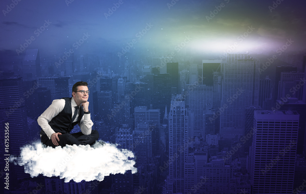 Man sitting on a cloud above the city Man sitting on a cloud above the city