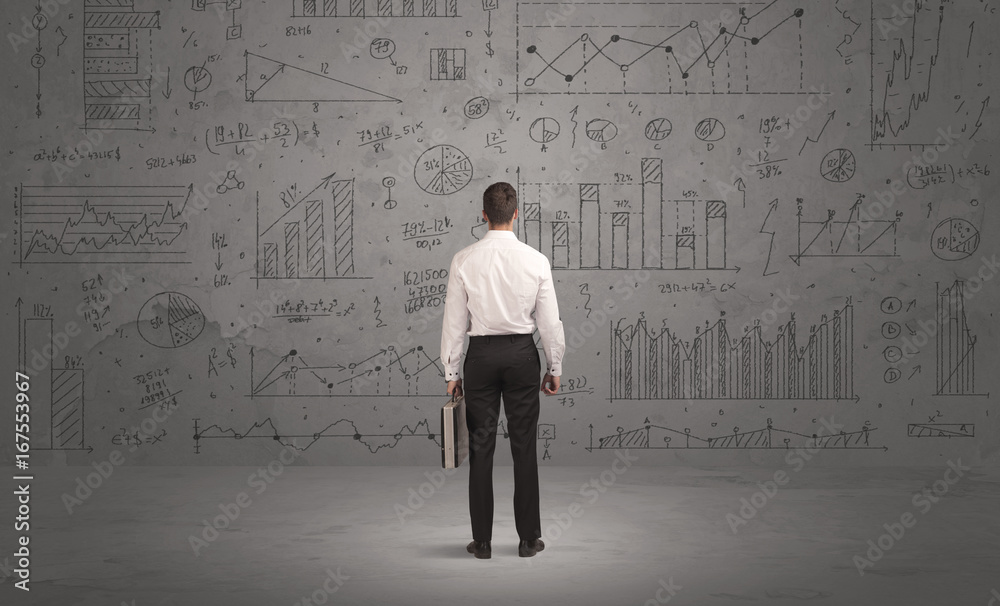 Salesman with business charts on wall Salesman with business charts on wall