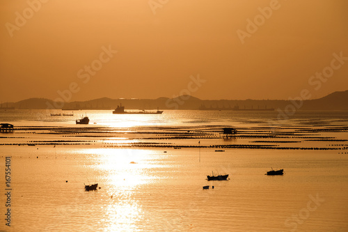 Isolate of Beautiful gold sunset at summer beach .