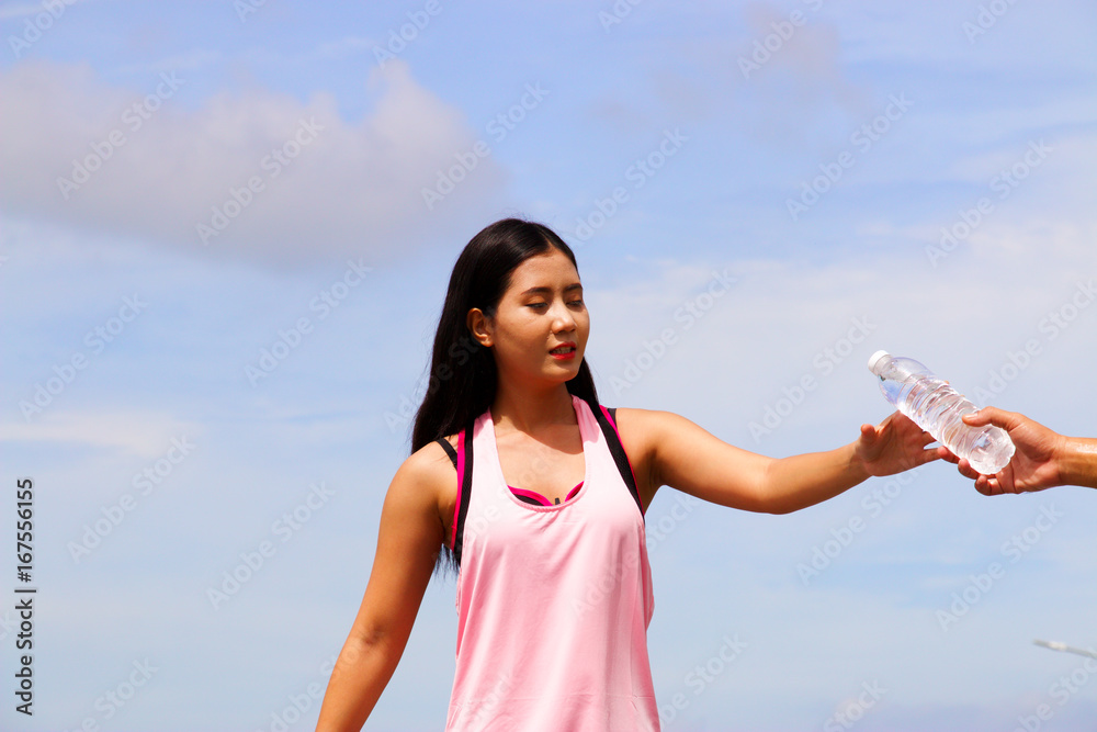 Sporty woman is drinking water Sporty woman is drinking water