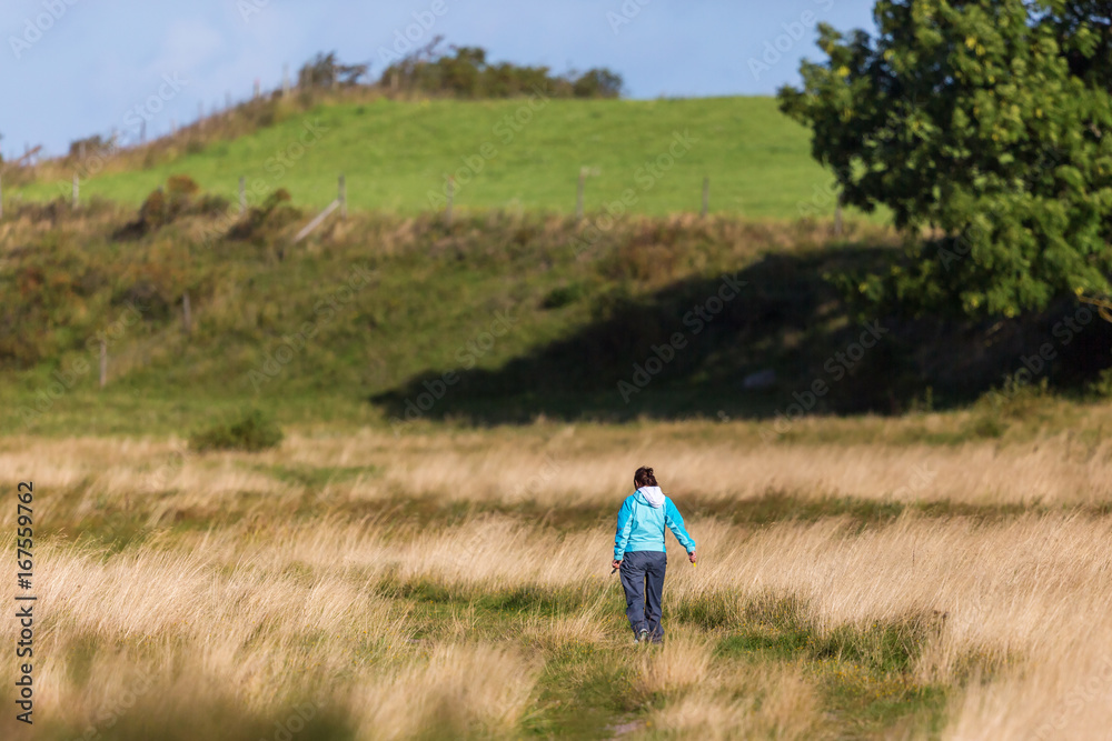 Woman walking on the meadow