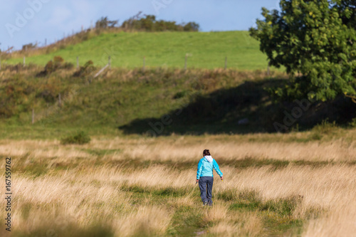 Woman walking on the meadow