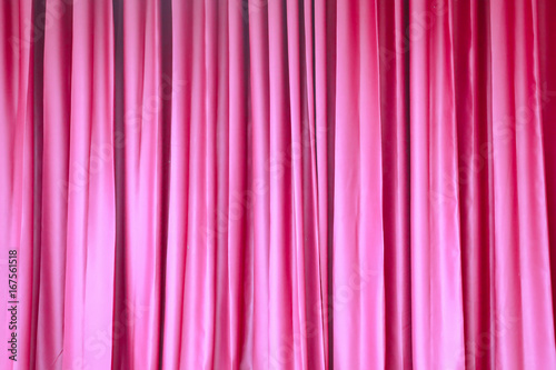 Red closed curtain with light spots in a theater