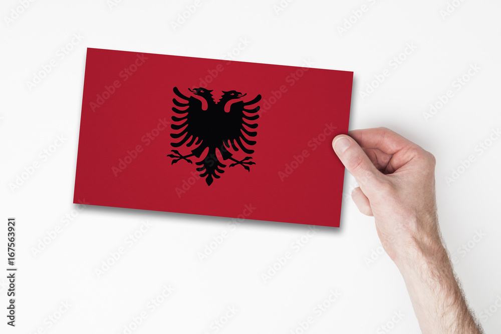 Male hand holding albania flag