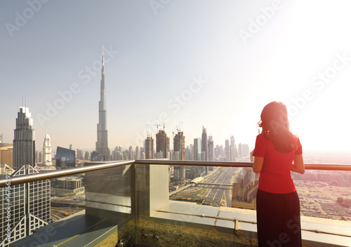 Asian woman overlooking the cityscape of Dubai