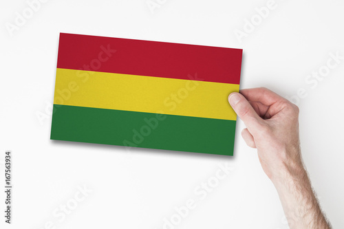 Male hand holding bolivia flag