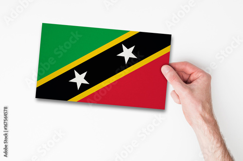 Male hand holding saint kitts flag © ink drop