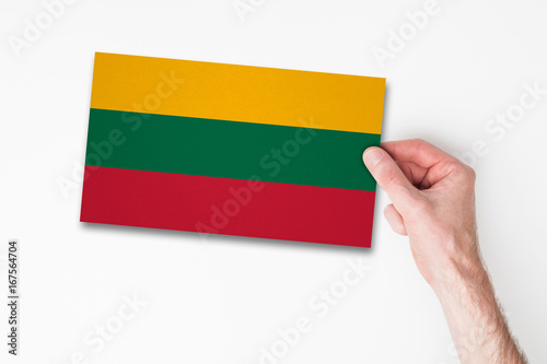 Male hand holding lithuania flag