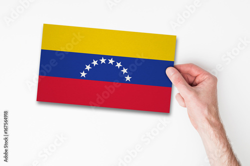 Male hand holding venezuela flag
