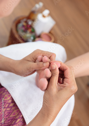 Foot massage in spa salon Thai massage.