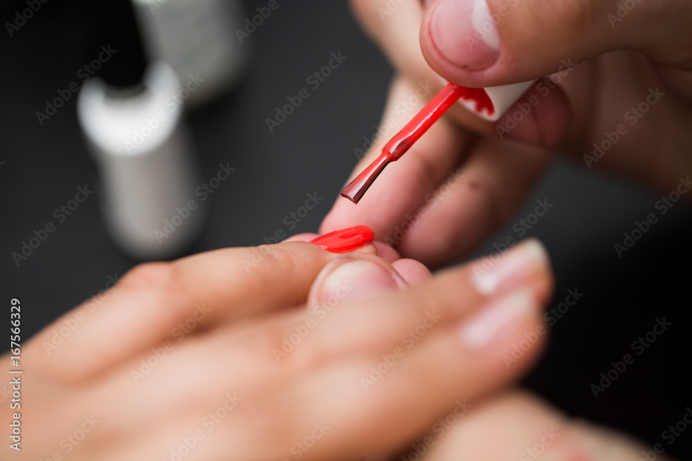 Closeup shot man making manicure to woman in beauty salon Closeup shot man making manicure to woman in beauty salon
