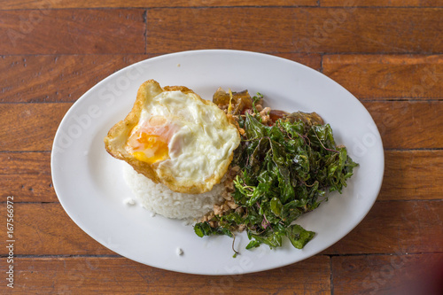 crispy basil herb pork and egg  with fried egg photo