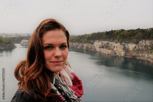 Young woman smiling and standing by lake, Budapest, Hungary © Aneta