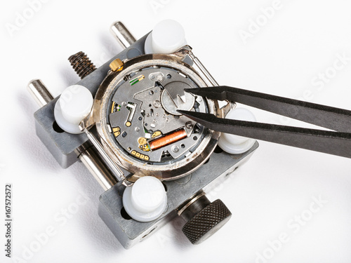 replacement battery in quartz watch with tweezers