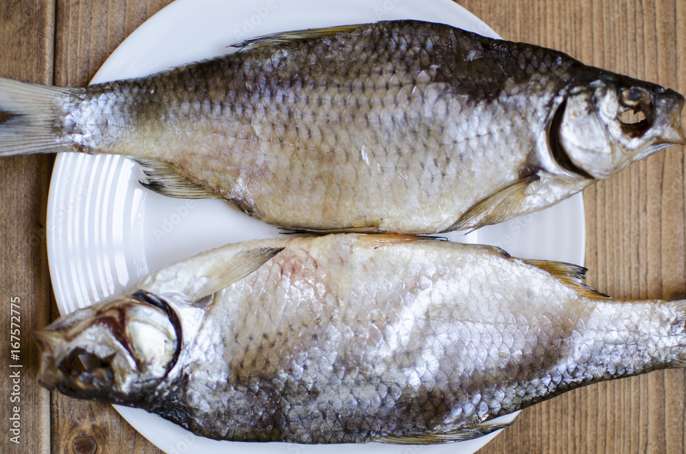 Freshwater fish. dried fish. salty fish on the wooden table. Freshwater fish. dried fish. salty fish on the wooden table.