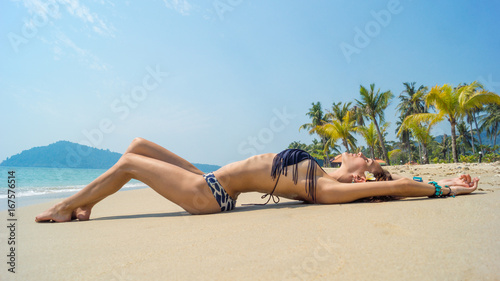 Beautiful, slender girl in bikini sunbathing
