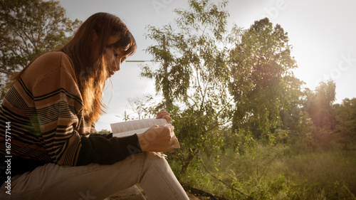 the woman reading the book at nature.