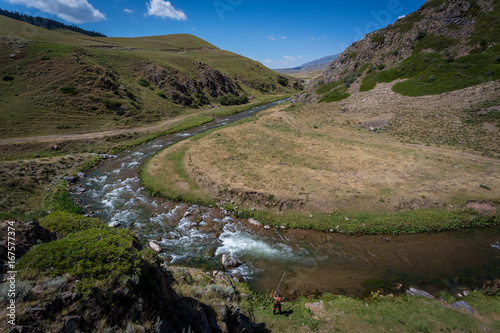 A fisherman on a mountain river