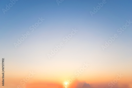 Sky background at sunset,Sky blue and orange light of the sun through the clouds in the sky