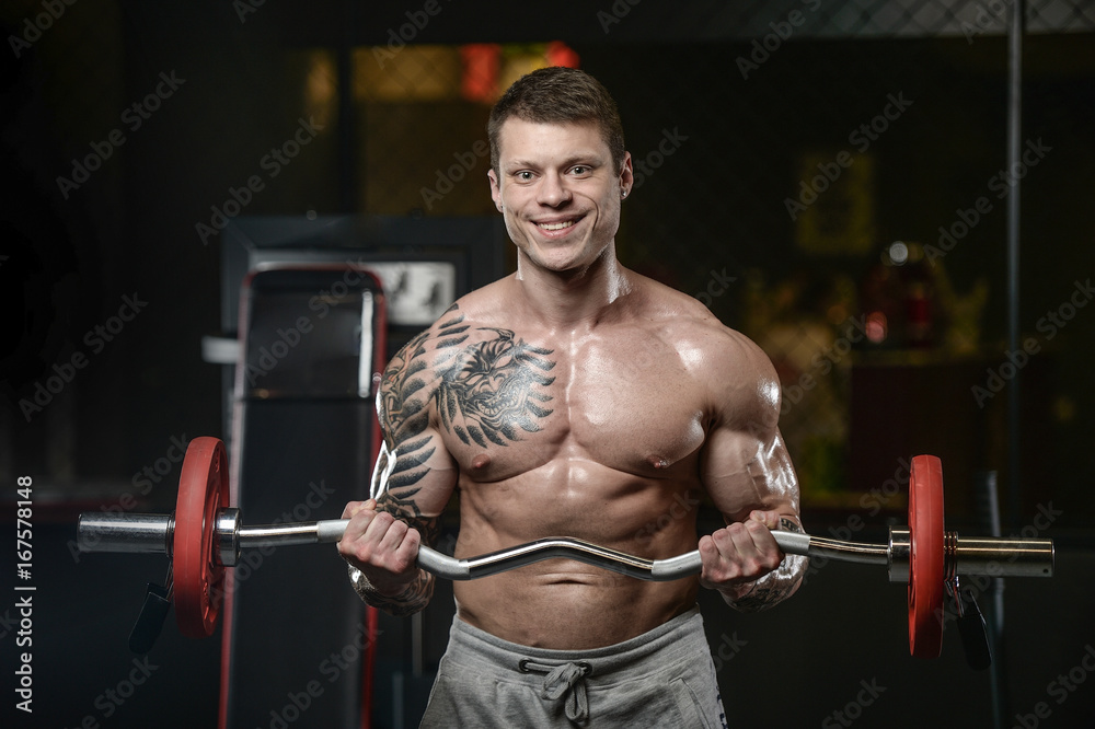 Strong and handsome athletic young tattoo man with muscles Strong and handsome athletic young tattoo man with muscles