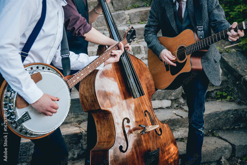 Fototapeta premium Trio of musicians with a guitar, banjo and contrabass