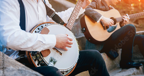 View of musician playing banjo at the street