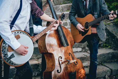 Trio of musicians with a guitar, banjo and contrabass photo
