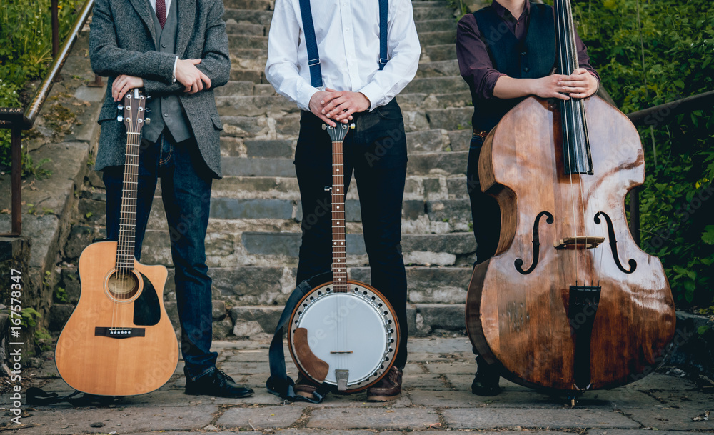 Fototapeta Trio of musicians with a guitar, banjo and contrabass